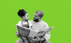 Black father and daughter reading