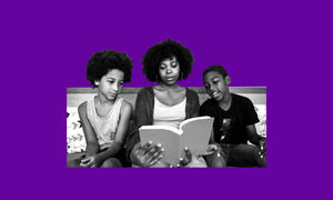 Adult woman and two children reading and discussing