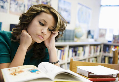 girl reading at library