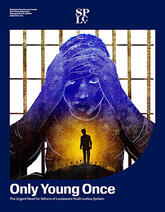 African American youth with their hands on their head, standing before bars